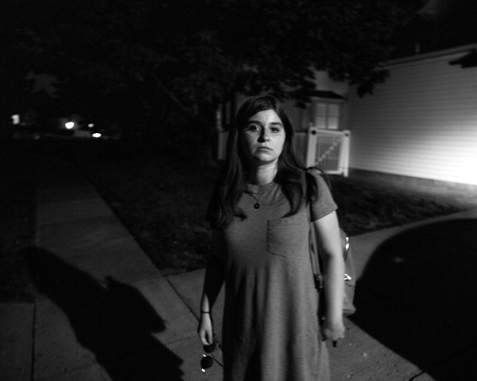 Emma stands outside her parents’ home
